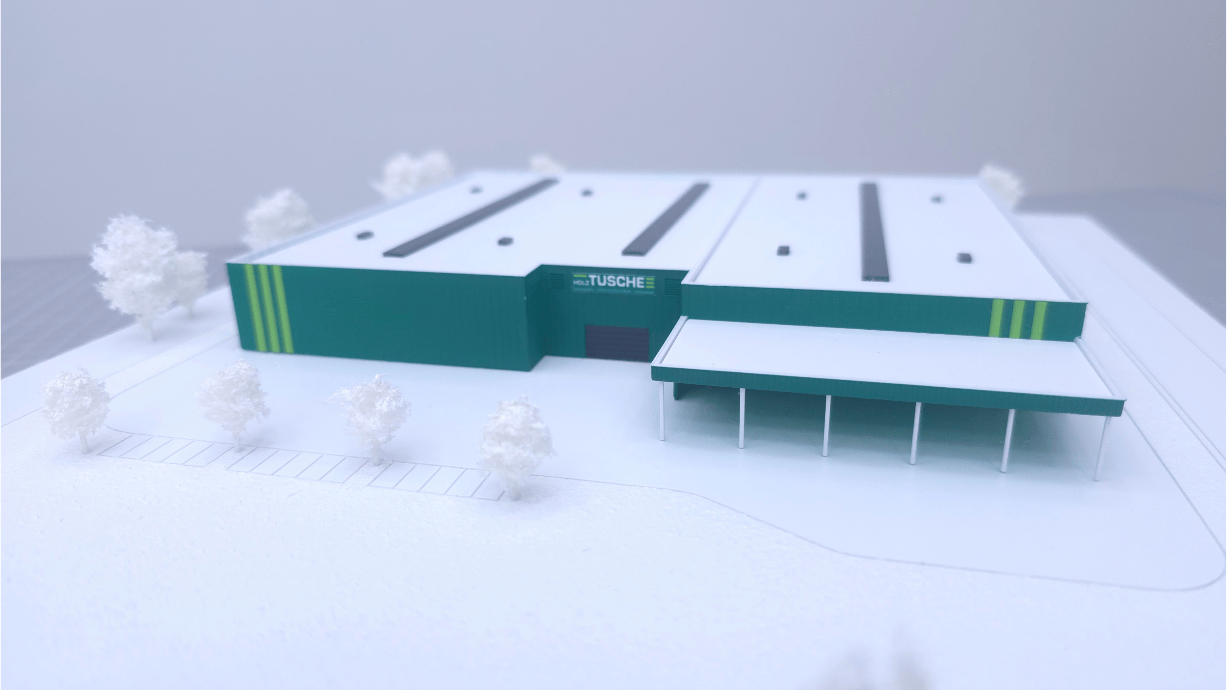 Frontansicht des Werksmodells von Holz Tusche mit Eingangsbereich, Vordach und markanter Fassadengliederung.